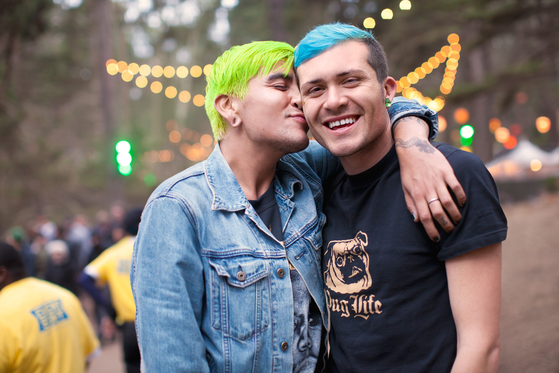 A man kisses his boyfriend while at a Northern California music festival