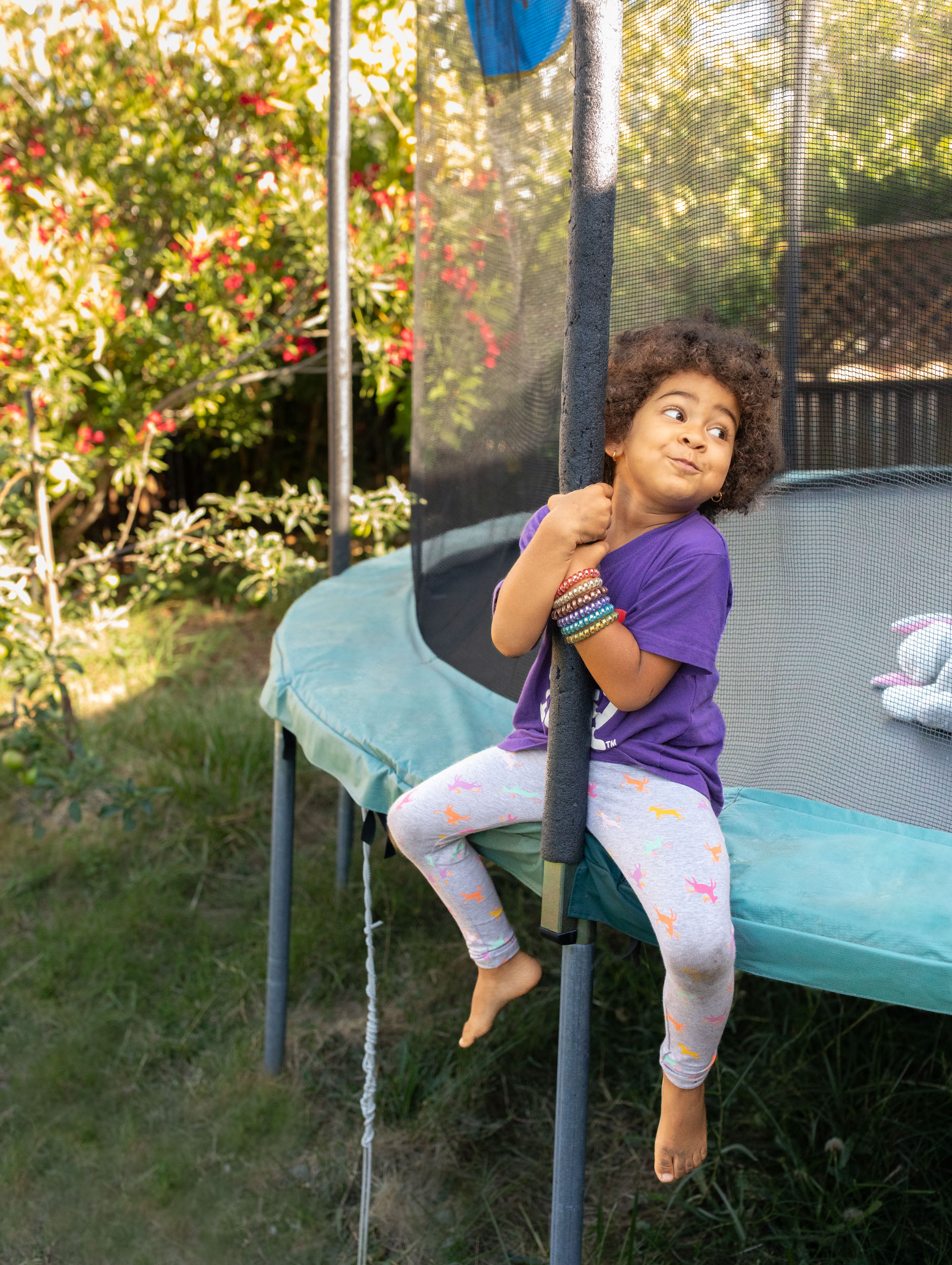 A 6-year-old girl plays on a trampoline at her family