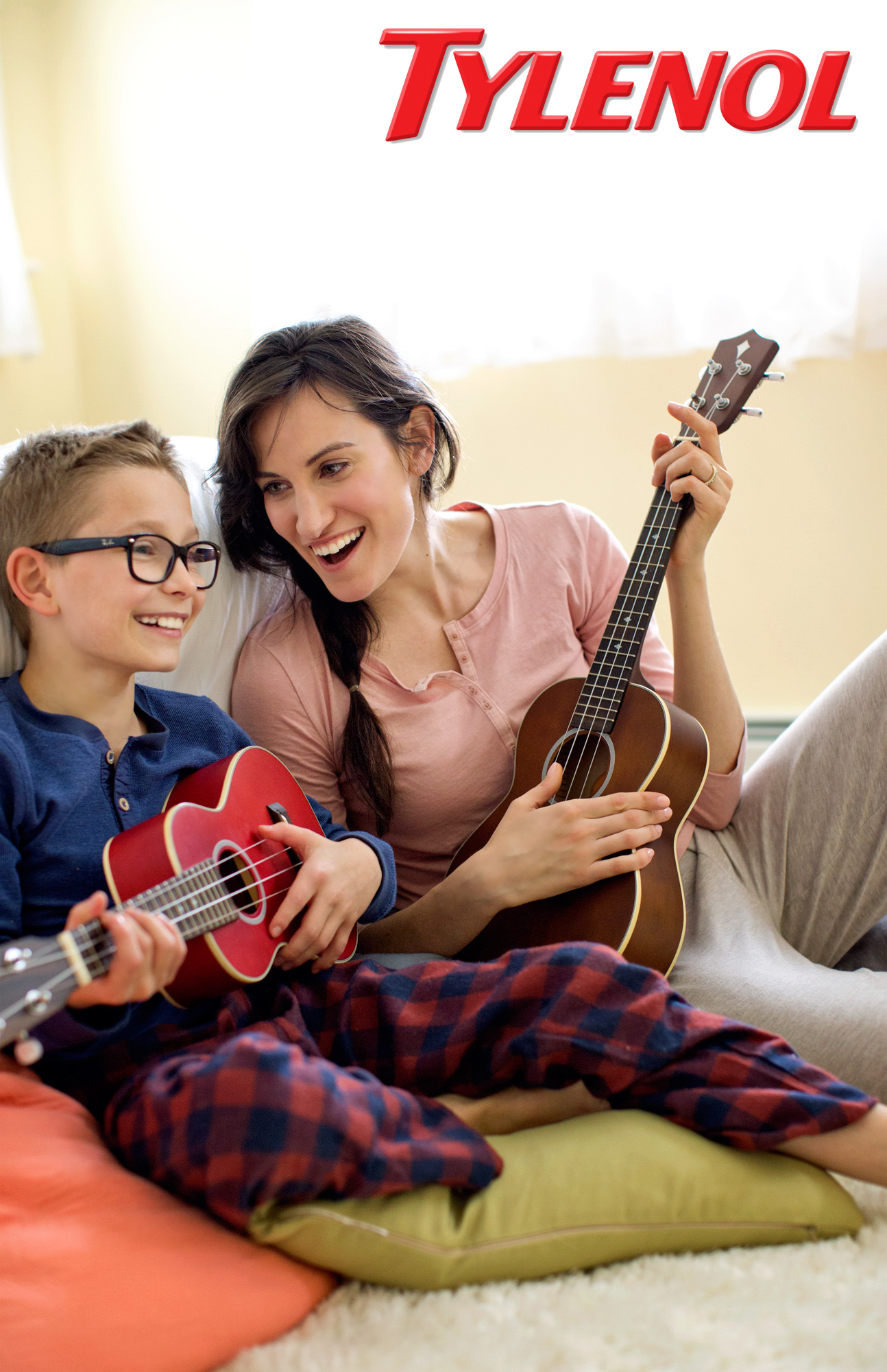 A woman plays ukulele with her son in a Tylenol Ad Campaign photographed by Lifestyle Photographer Diana Mulvihill