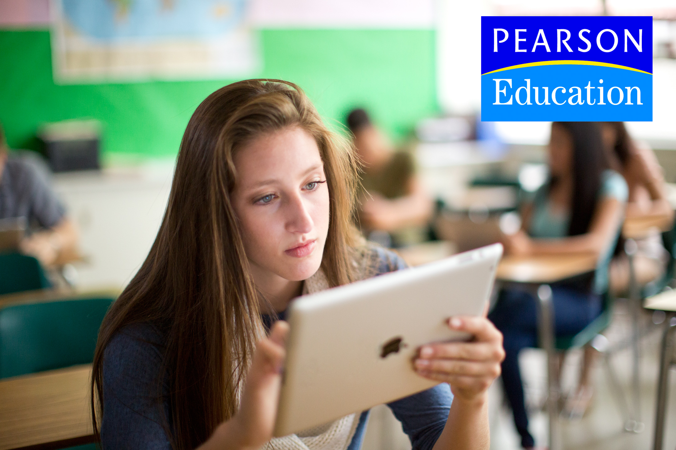 A teen girl works on an iPad in a classroom in an Ad Campaign for Pearson Education photographed by Lifestyle Photographer Diana Mulvihill