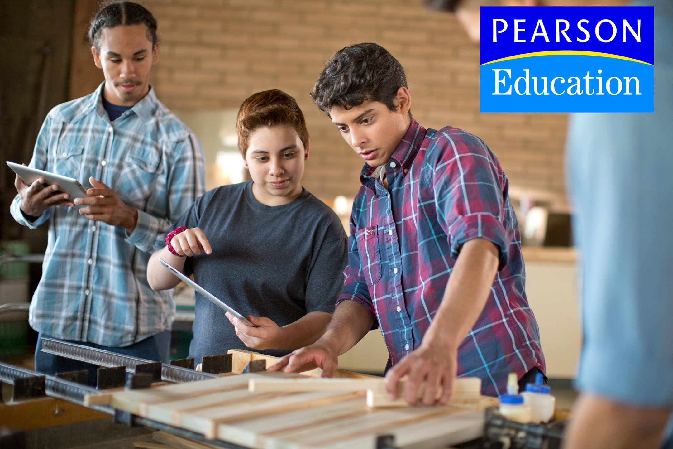 Teens work together in a wood shop in an Ad Campaign for Pearson Education photographed by Lifestyle Photographer Diana Mulvihill