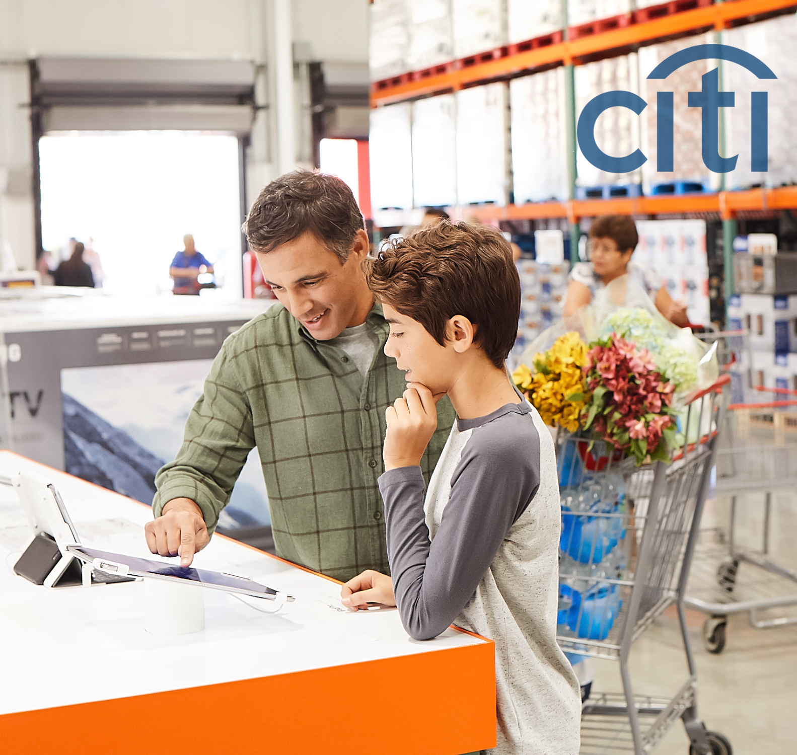 A father and his son look at iPads at Costco in a Citibank Ad Campaign photographed by Lifestyle Photographer Diana Mulvihill