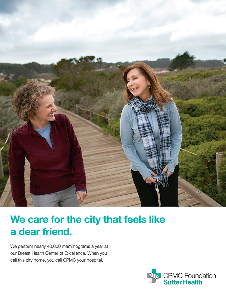 Two women walk together on a boardwalk in nature in a Healthcare Ad Campaign photographed by Lifestyle Photographer Diana Mulvihill